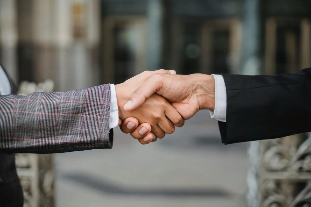 Imagen de dos personas dándose la mano en un gesto de cerrar un trato.